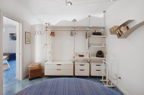 a room with white cabinets and a blue rug at Casa Il Geco Praiano in Praiano