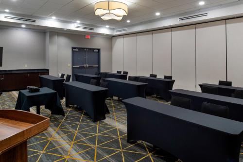 a conference room with black tables and chairs at Holiday Inn Rock Hill by IHG in Rock Hill