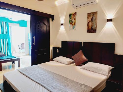 a bedroom with a large bed with white sheets at Porto Marina North Cost, Coastal Panorama in El Alamein
