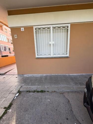 a building with a window with bars on it at Ohana Dream House in Alghero