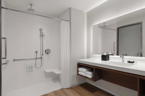 a bathroom with a sink and a shower at AC Hotel Pasadena in Pasadena
