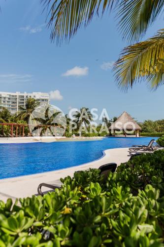 a view of a swimming pool at a resort at CARlBE Beachfront 2BDR with pool by Casa Paraiso in Cancún