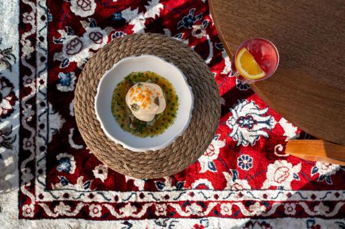 a plate of food on a table with a bowl of food at Restia in Almiros Beach