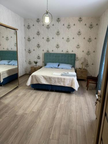 a bedroom with a bed and a mirror in it at Hotel DADU in Samtredia