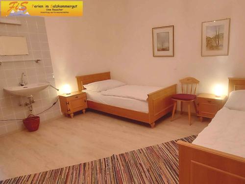 a bedroom with a bed and a sink and a bed sidx sidx sidx at Apartment in Bad Mitterndorf - Steiermark 36996 in Bad Mitterndorf