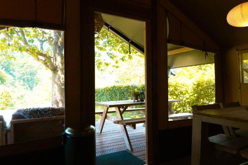 a view from the inside of a house with a porch at Camping De Bosrand in Sint Geertruid