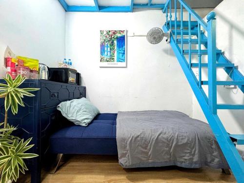 a blue bed in a room with a blue staircase at Heart of Hoan Kiem-RARE 5BR Private house unique design travel hub 13pax in Hanoi