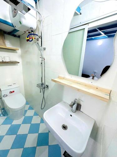 a bathroom with a sink and a toilet and a mirror at Heart of Hoan Kiem-RARE 5BR Private house unique design travel hub 13pax in Hanoi