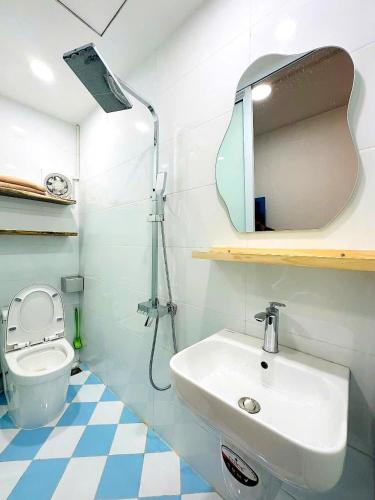 a bathroom with a sink and a mirror and a toilet at Heart of Hoan Kiem-RARE 5BR Private house unique design travel hub 13pax in Hanoi
