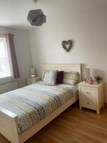 a bedroom with a bed and two night stands at Portstewart Escape in Portstewart