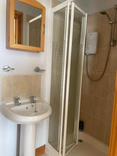 a bathroom with a sink and a shower at Portstewart Escape in Portstewart