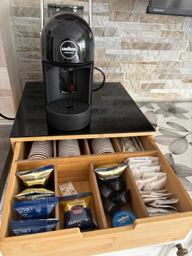 a coffee maker sitting on top of a wooden drawer at Ohana Dream House in Alghero