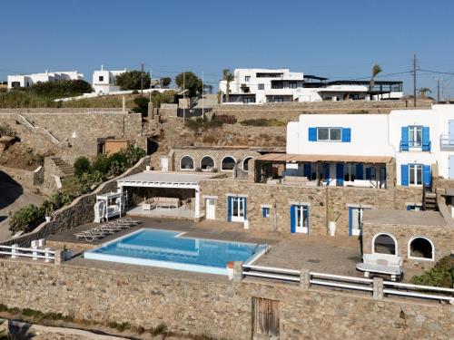 a villa with a swimming pool on top of a building at Salty Blè in Agios Ioannis Mykonos