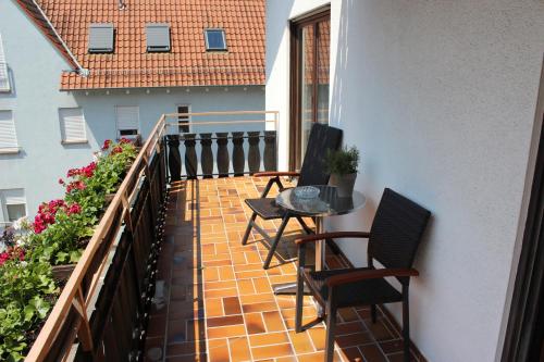 a balcony with two chairs and a table on a balcony at Gasthof und Pension zum Löwen in Hirschberg an der Bergstraße