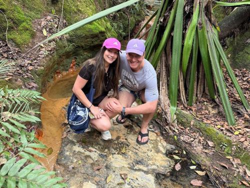 a man and a woman kneeling on a rock in a forest at Hotel Alma in Villa de Leyva