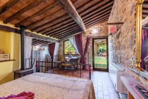 a bedroom with a large bed in a room at Agriturismo Podere Marroneto in Monticiano