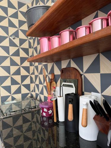 a kitchen counter with pink cups and utensils at Paraíso dos Lençóis casa 08 Atins in Atins