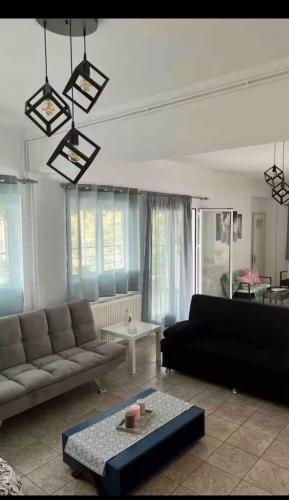 a living room with a couch and a table at Vila Veta in Galatas
