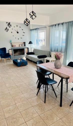 a living room with a table and chairs and a couch at Vila Veta in Galatas