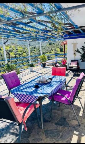 a table with purple chairs on a patio at Vila Veta in Galatas