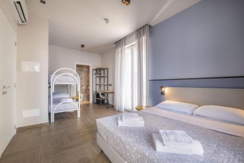 a bedroom with a large bed and a desk at Global Hotel in Rimini