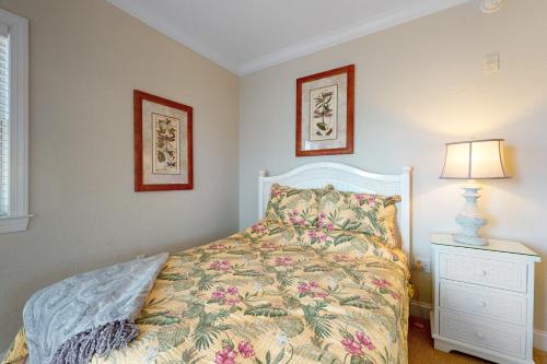 a bedroom with a bed and a lamp on a night stand at Condo 4100 #201 in Ocean City