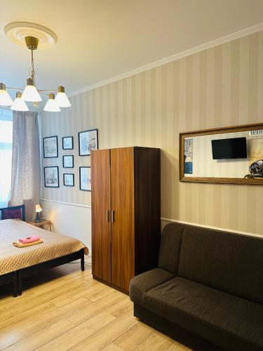 a living room with a couch and a cabinet at Happy8 in Gdynia
