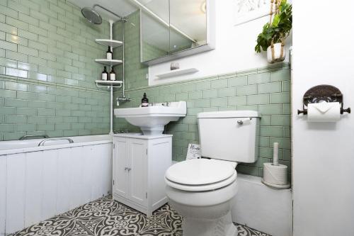 a bathroom with a white toilet and a sink at The Rabbit Hole in Langford
