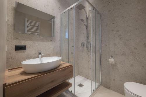 a bathroom with a sink and a glass shower at Global Hotel in Rimini