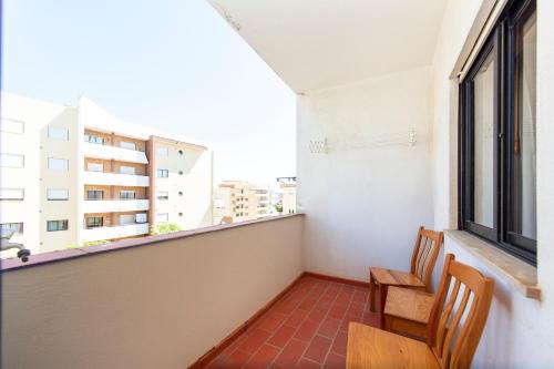 a balcony with two chairs and a window at Amaro Sight Guesthouse in Lagos