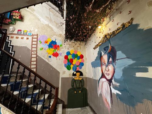 a painting of a woman on a wall at ECO Hostel in Granada