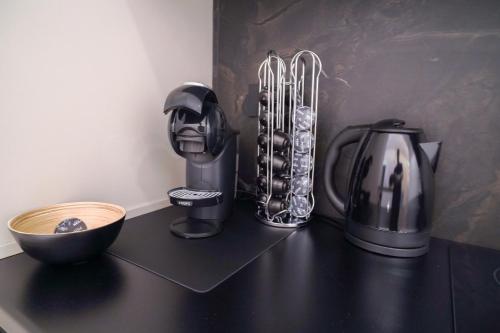 a counter top with a coffee maker and a mixer at Virginia Madre Luxury Rooms in San Benedetto del Tronto