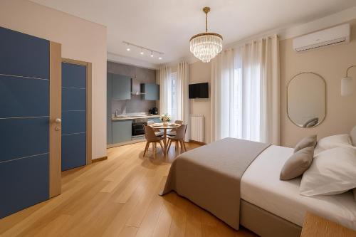a bedroom with a bed and a table and a kitchen at Sea Pearl Luxury Rooms in La Spezia