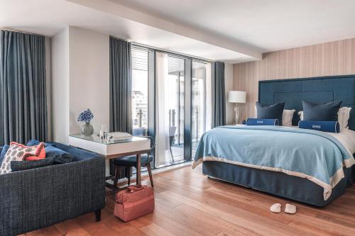 a bedroom with a bed and a desk and a couch at Harbour Hotel & Spa Southampton in Southampton