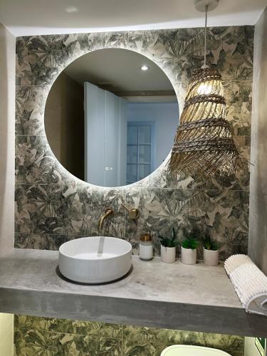 a bathroom with a sink and a mirror at Casas do Largo- Primavera in Estremoz