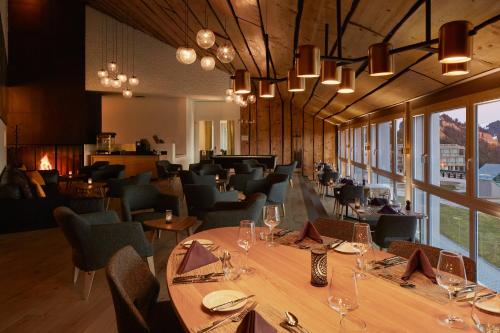 a restaurant with a long table and chairs at Rigi Kaltbad Swiss Quality Hotel in Rigi Kaltbad