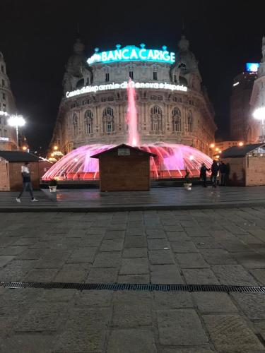 a fountain in front of a building at night at Attico Palazzo Giustiniani in Genova