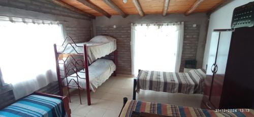 a room with two bunk beds and a window at Entrepinos I in Juana Koslay 
