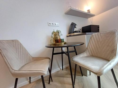 two chairs and a table in a small kitchen at Luise LuXe Suites in Tallinn