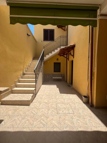an empty hallway of a building with a staircase at Casa Martina in Tre Fontane