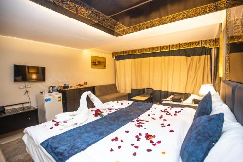 a hotel room with a bed with flowers on it at Comfort in Cairo