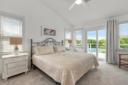 a white bedroom with a bed and a window at Rx To Relax in Duck