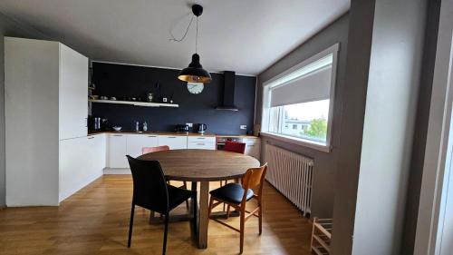 a kitchen with a table and chairs in a room at Your Icelandic home in Reykjavik in Reykjavík