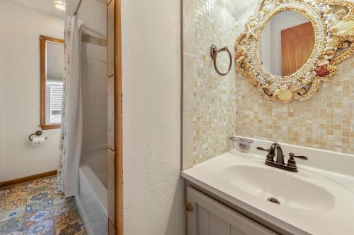 a bathroom with a sink and a mirror at Rose Cottage in Rodanthe