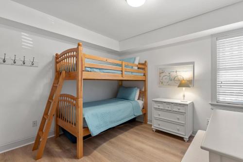 a bedroom with a bunk bed and a desk at Rx To Relax in Duck