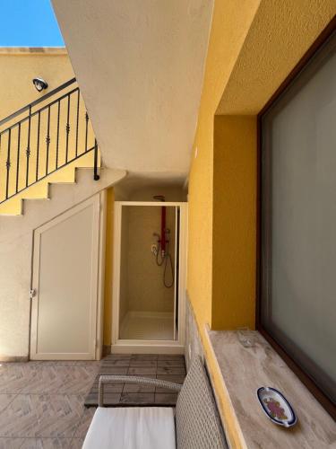 a room with a staircase and a door with a door at Casa Martina in Tre Fontane