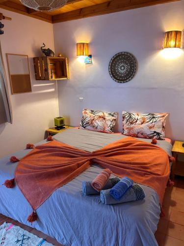 a bedroom with a large bed with blankets on it at Tigmi Blue - Imsouane Surf et Océan in Imsouane