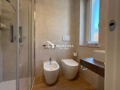 a bathroom with a toilet and a sink and a shower at DEALCASA Guest House in Nuoro