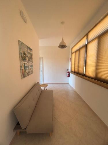 a living room with a couch and a window at Casa Martina in Tre Fontane