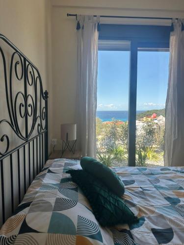 a bedroom with a bed with a view of the ocean at Nicks sea view appartement II in Petrovac na Moru